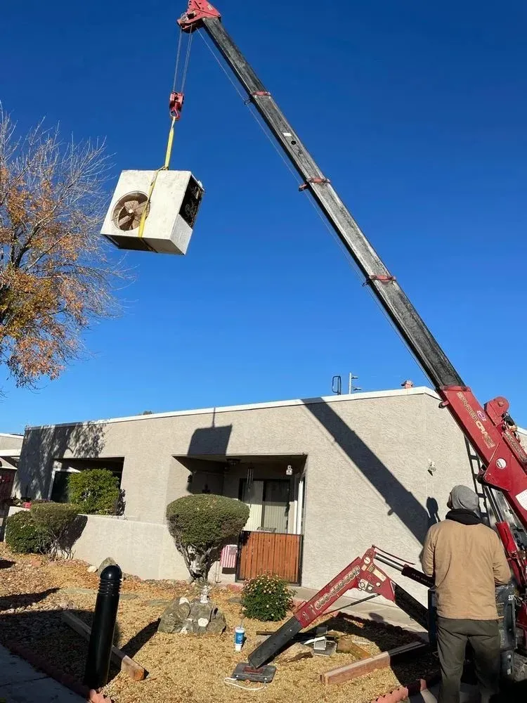 Extend HVAC Life: Essential Tips for Your System's Longevity 2 Outdoor HVAC unit being prepared for seasonal maintenance tasks